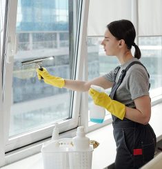 young-female-cleaner-spraying-detergent-on-window-2023-11-27-04-53-13-B3228B9.jpg